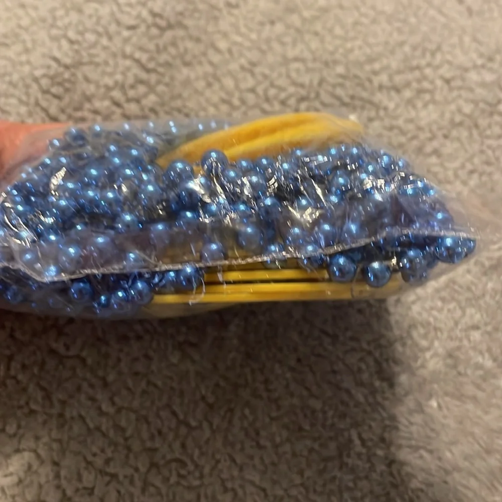 12 Corona Light Yellow Coasters with Blue Beads necklace